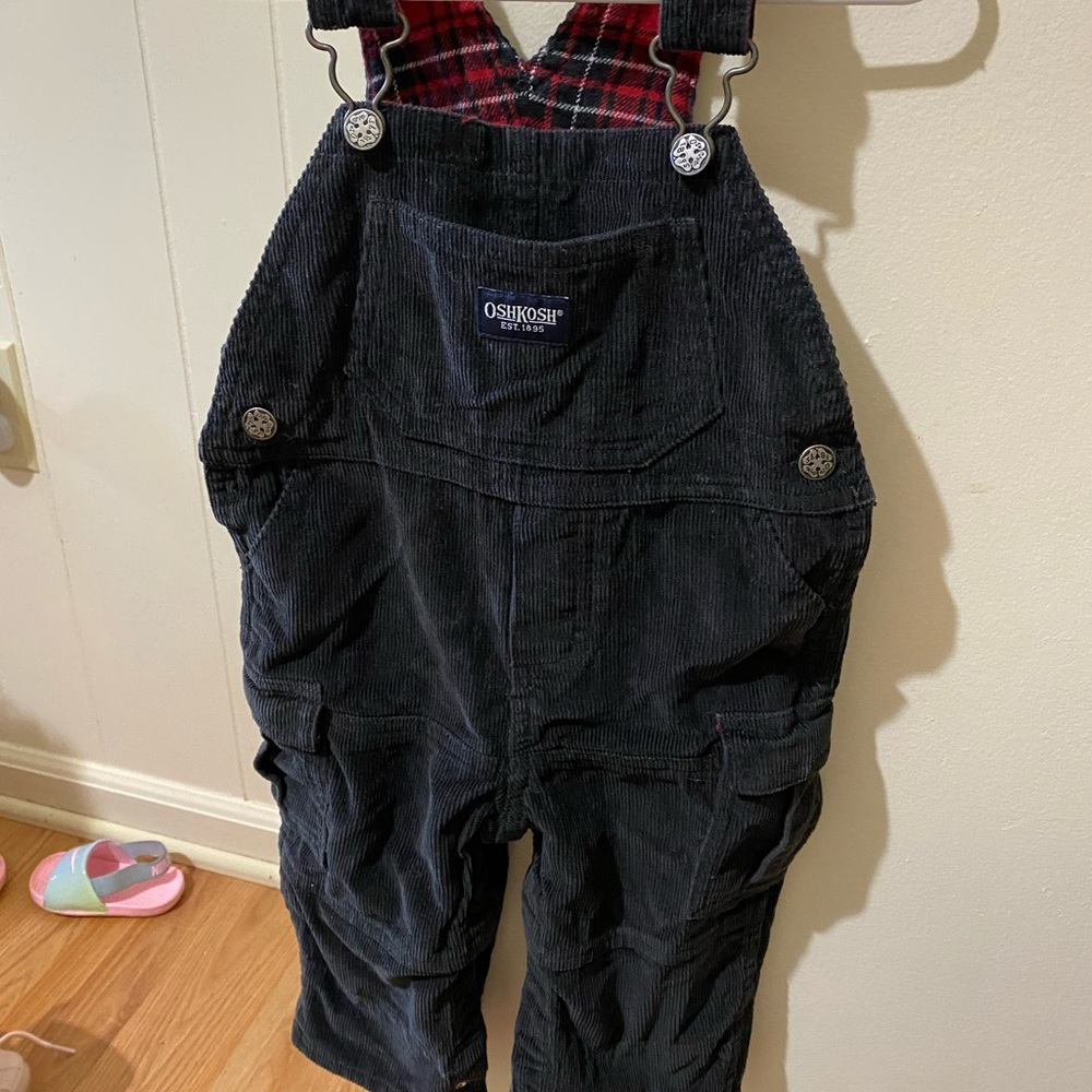OSHKOSH black velvet overalls with red plaid inside.